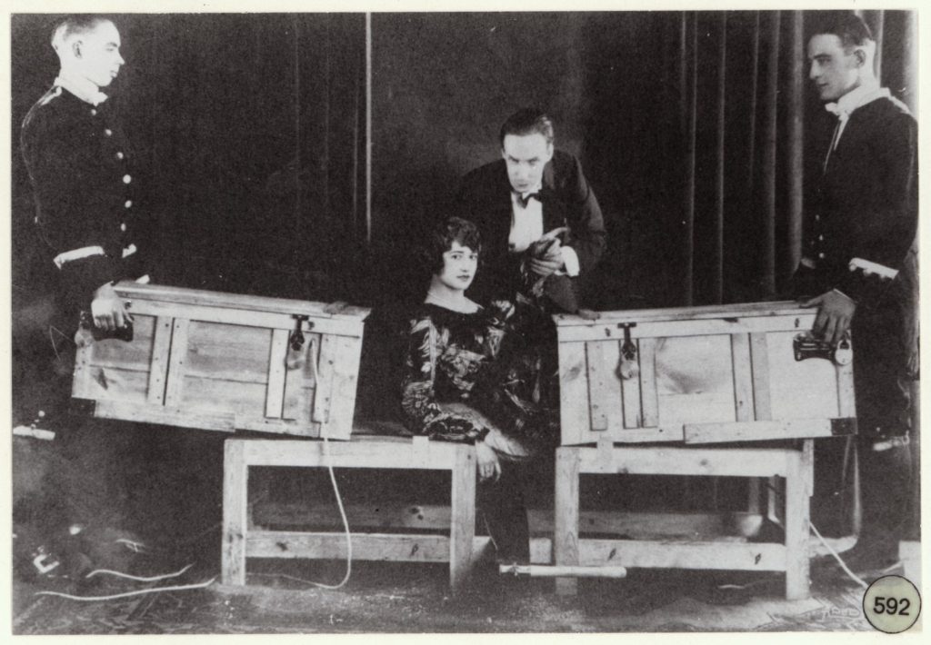 Magician P.T. Selbit sawing a woman in half