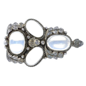 An Arts and Crafts silver moonstone brooch, with acorn and oak leaf motif, attributed to Bernard Instone