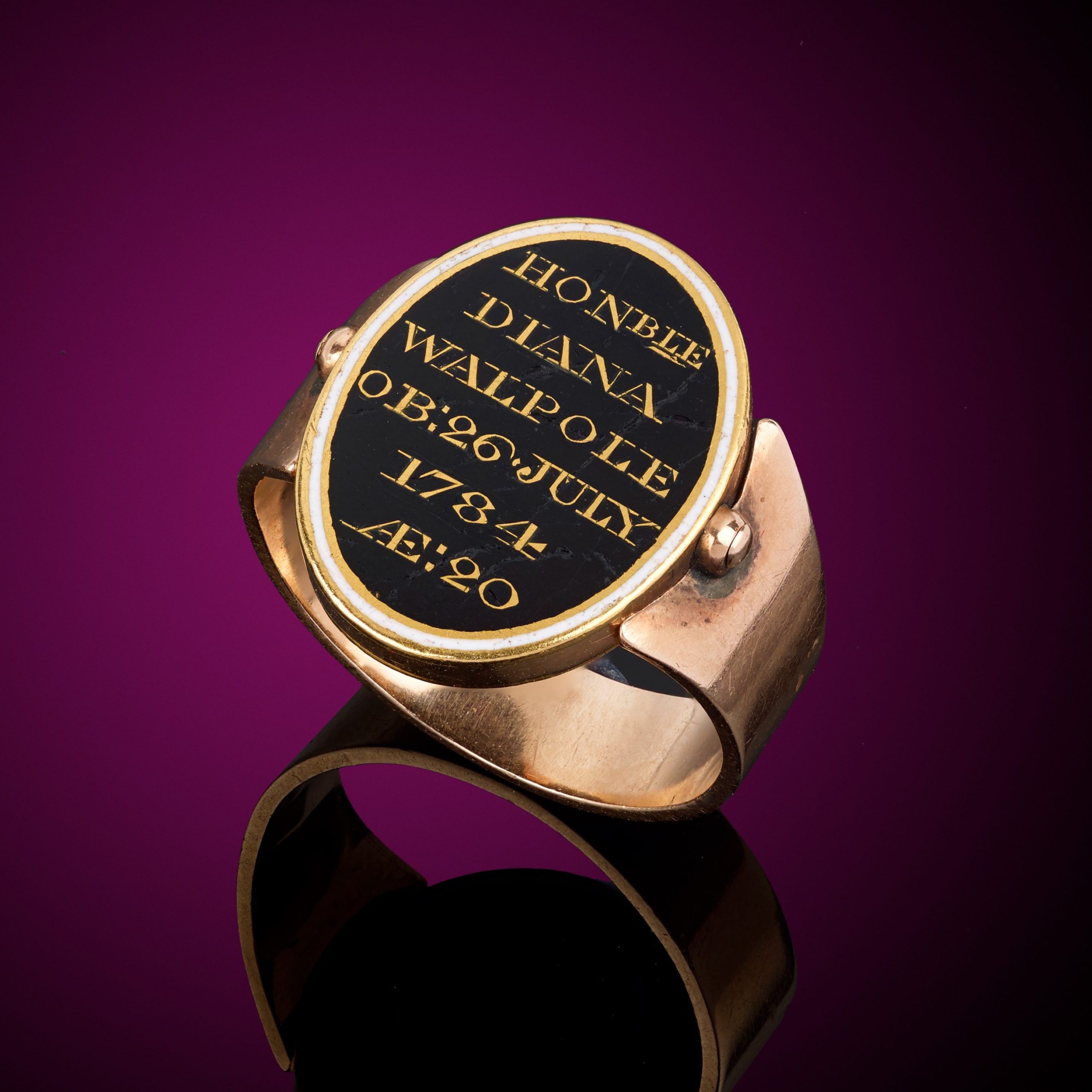 Diana Walpole's mourning ring. A Georgian gold black and white enamel mourning swivel ring, with braided hairwork locket, for the Honourable Diana Walpole.