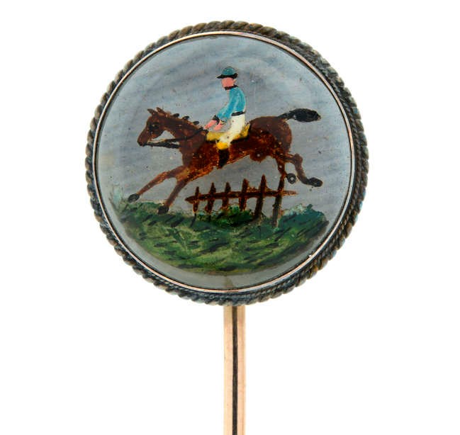 A late Victorian Essex crystal stickpin depicting a horse riding scene.